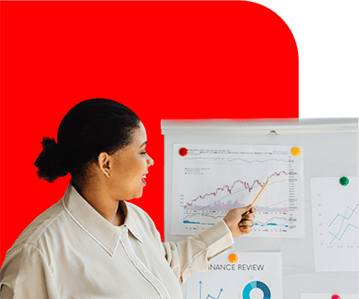 Woman teaching financial concepts at a whiteboard.